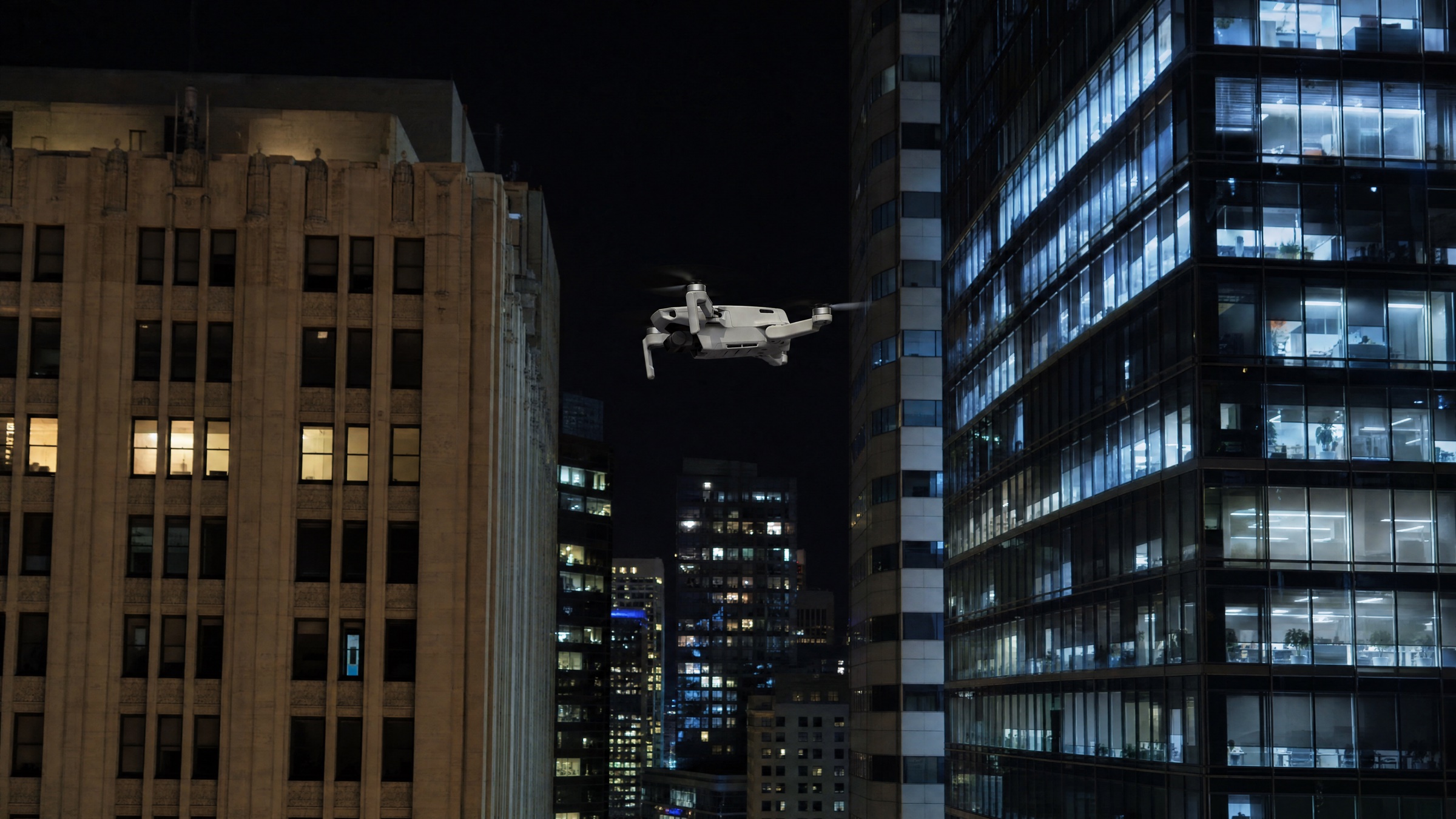 Editorial illustration of a small consumer drone hovering between downtown skyscrapers at night, depicting a multi-rule recreational flight violation